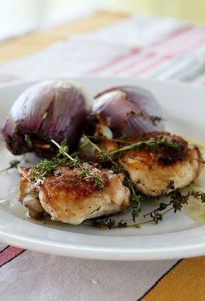 Roast chicken with whole red onions and thyme
