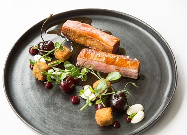 Roast duck breast and crispy leg croquettes with cherries and almonds
