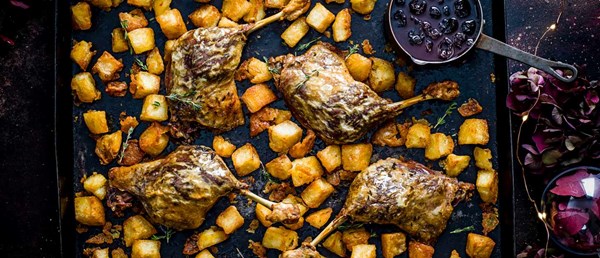 Roast duck with crispy potatoes and mulled-wine cherry sauce