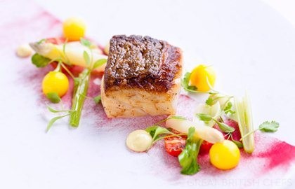 Roast fillet of cod with saffron potatoes and tomatoes