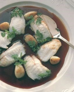 Roast fillet of monkfish with roasted cloves of garlic and a rich red wine sauce [Ian McAndrew]