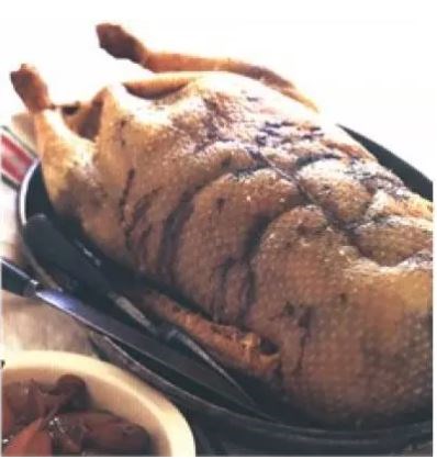 Roast goose with potato, sage and apple stuffing served with spiced pickled pears