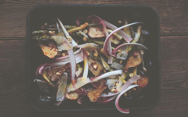 Roast Jerusalem artichokes and leeks with crème fraîche, shaved Gouda and hazelnuts
