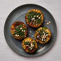 Roast kohlrabi with herb oil and fried almonds