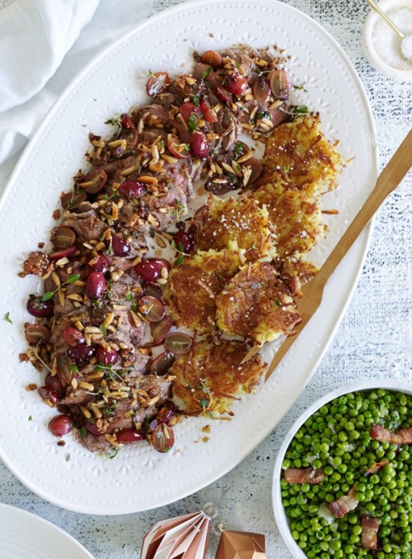 Roast lamb with lemon crust and damson jus, pan-fried grapes and almonds