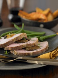 Roast loin of pork stuffed with apricots and dried plums