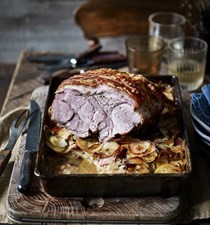 Roast pork on a bed of cider-soaked potatoes