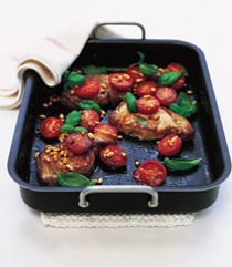 Roast pork steaks with vine tomatoes and pine nuts