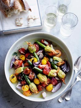 Roast stuffed zucchini flowers with tomato and oregano
