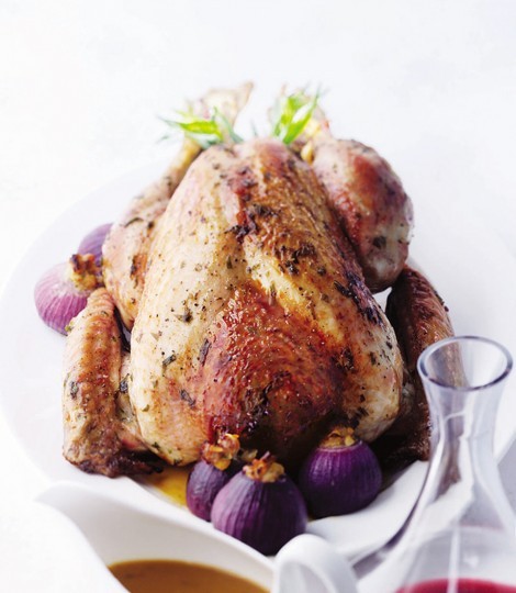 Roast tarragon and lemon turkey with stuffing-filled onions