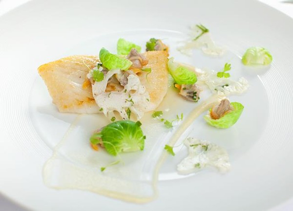 Roast turbot with cauliflower carpaccio, sauté of sprout leafs, cockles, bay leaves and bread sauce