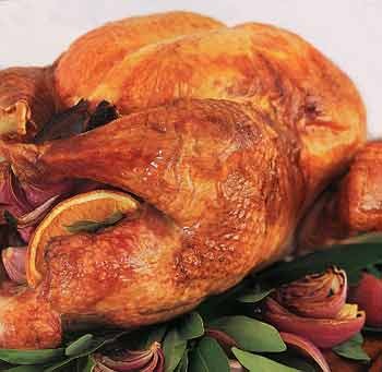 Roast turkey with oranges, bay leaves, red onions, and pan gravy