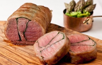 Roast whole saddle of lamb with spinach and black pudding
