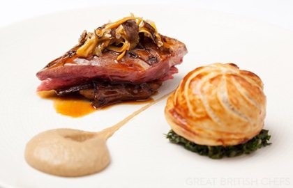Roast wood pigeon with pithivier of leg, creamed curly kale and roast Jerusalem artichokes