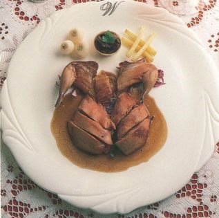 Roast young partridges on a bed of cabbage with its juices