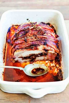Roasted bacon-wrapped pork loin with prune stuffing