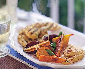 Roasted beets and carrots with cumin vinaigrette, chickpea puree, and flatbread