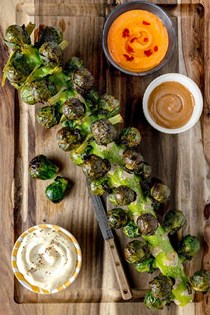 Roasted Brussels sprouts stalk with 3 dips [spicy peanut sauce, Dijon aioli, roasted red pepper feta dip]