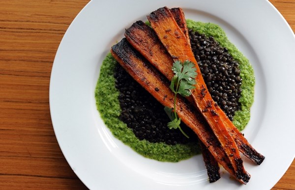 Roasted carrots with black lentils and green harissa