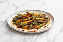 Roasted carrots with ricotta, harissa oil, carrot top pesto and pumpkin seeds