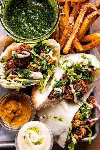 Roasted cauliflower pitas with zhug and garlic tahini
