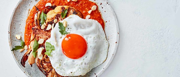 Roasted cauliflower steaks with romesco and fried eggs