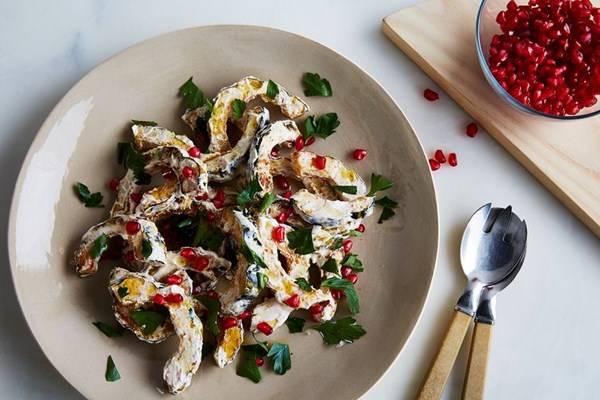Roasted delicata squash with spicy yogurt dressing and pomegranate