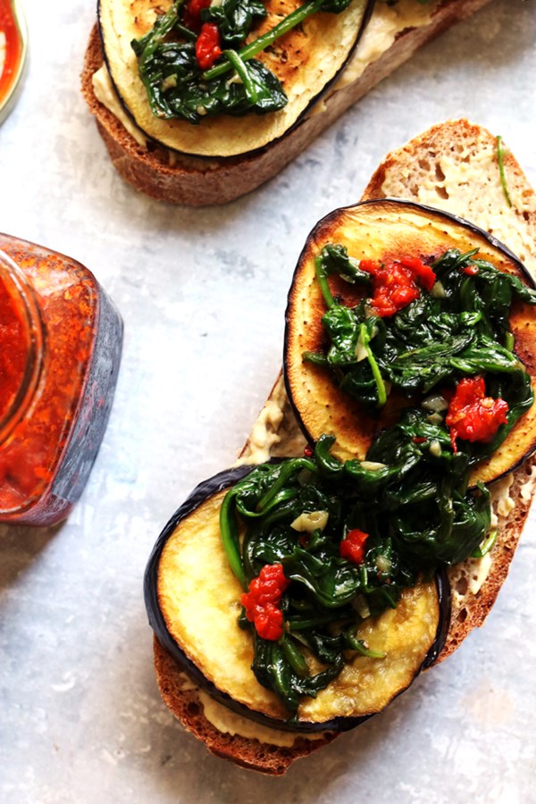 Roasted eggplant and hummus tartines with harissa and garlicky spinch