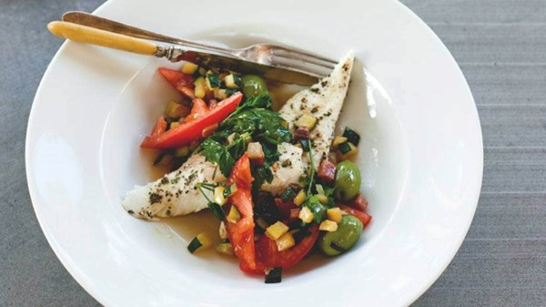 Roasted fish with tomatoes, zucchini, pancetta and green olives