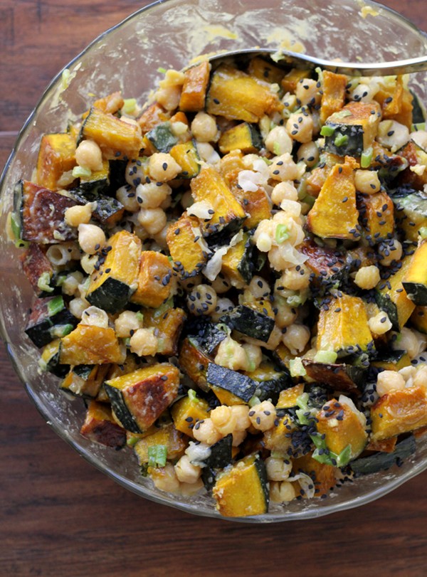 Roasted kabocha squash and chickpea salad with tahini, scallions and black sesame seeds