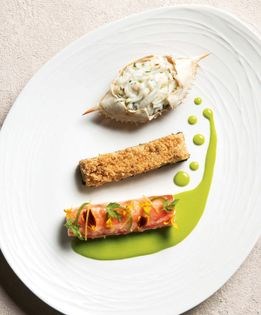 Roasted king crab legs with jalapeño-hazelnut vinaigrette and black trumpet and grapefruit crumble