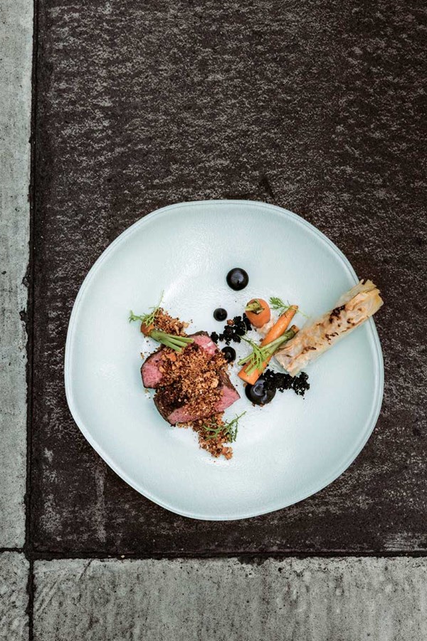 Roasted lamb rump, schnitzel crumb, lamb-shoulder cigar & leek ash
