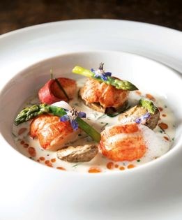 Roasted Maine lobster in a folly of herbs with green asparagus and fingerling potatoes