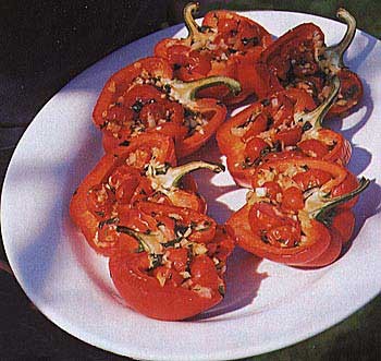 Roasted peppers stuffed with cherry tomatoes, onion, and basil