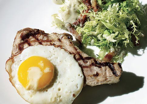 Roasted pork chops with frisée, lardons, and fried eggs