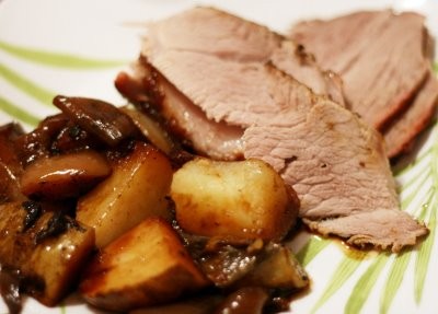 Roasted pork with caramelized onions and roasted potatoes and apples