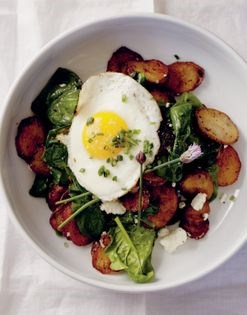 Roasted potato, spinach, and goat cheese with an egg on top