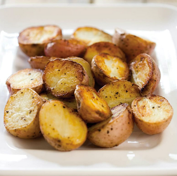Roasted potatoes with garlic, feta, olives, and oregano