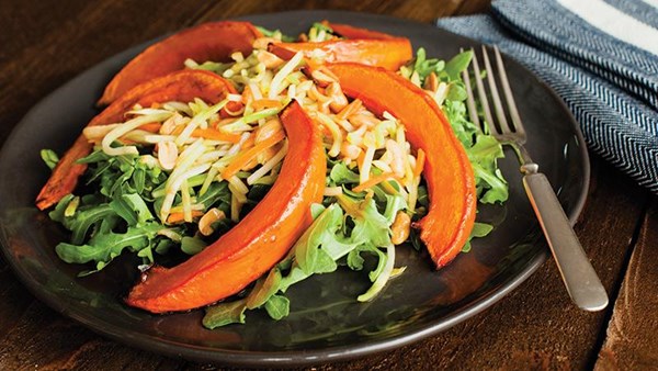 Roasted pumpkin slices over spicy broccoli slaw