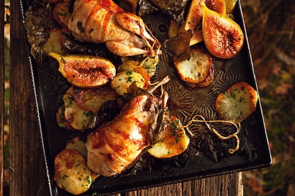 Roasted quails in vine leaves with figs and crispy bacon