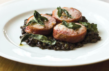 Roasted rabbit saddle with bread and sage stuffing and braised lentils