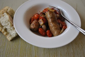 Roasted sausages with tomatoes and onions