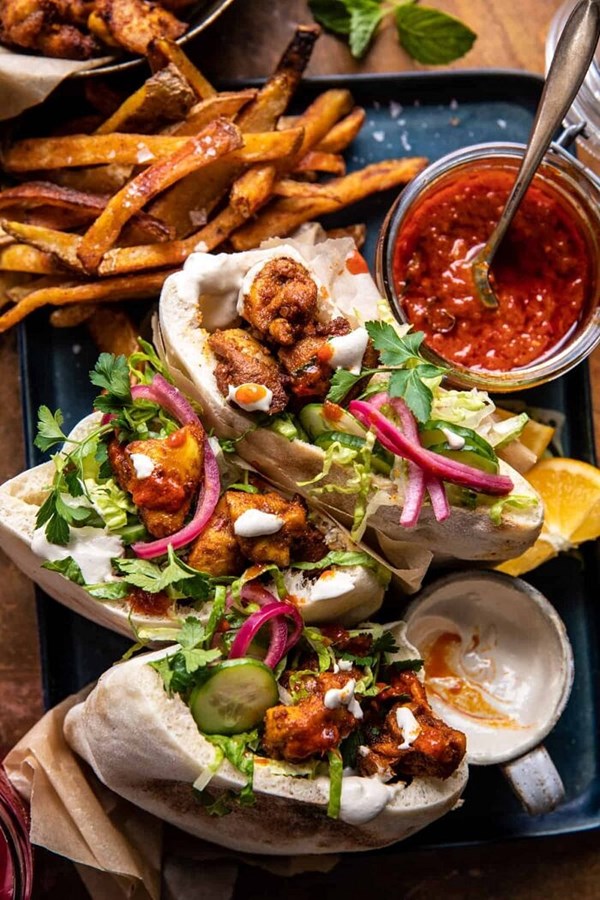 Roasted turmeric chicken pitas with garlic lemon tahini (+ spiced harissa sauce)