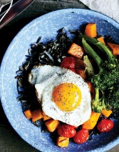 Roasted vegetable bowls with fried eggs and goat cheese
