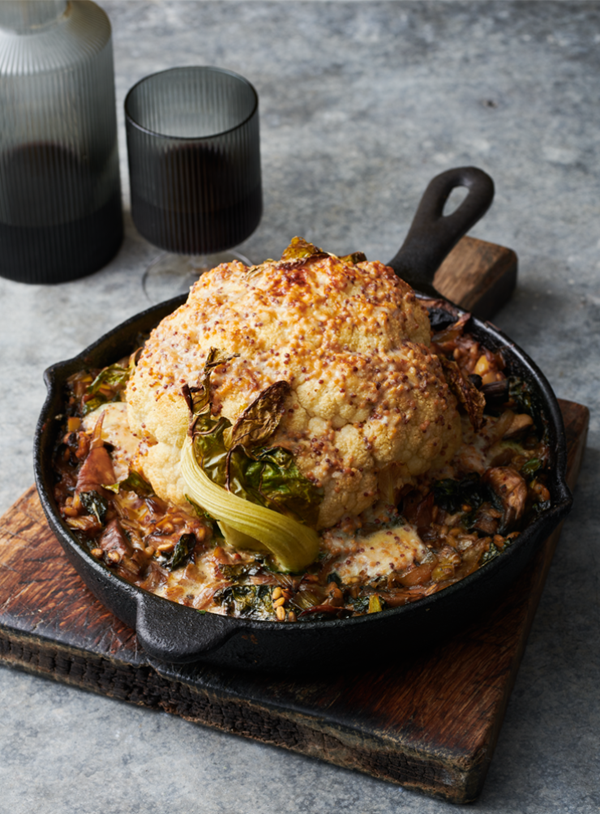 Roasted whole cauliflower on barley and leeks