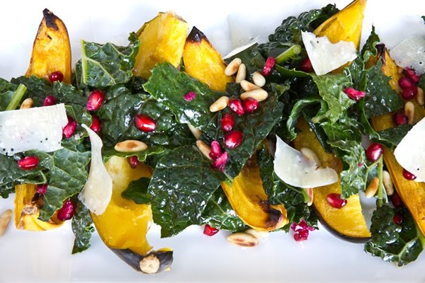 Roasted winter squash with kale and pomegranate seeds