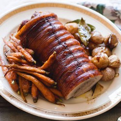 Rolled pork belly cooked in red wine and bay leaves