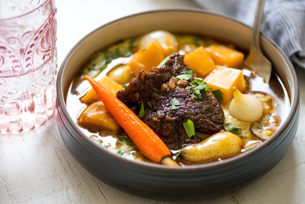 Root vegetable beef stew with mushroom and spinach polenta