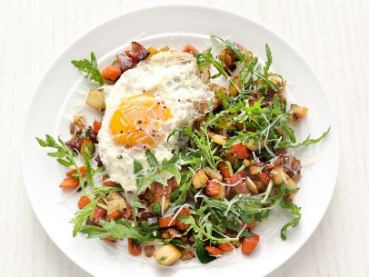 Root vegetable salad with fried eggs