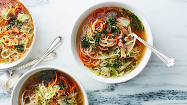 Root vegetable zoodle soup with bacon and basil oil